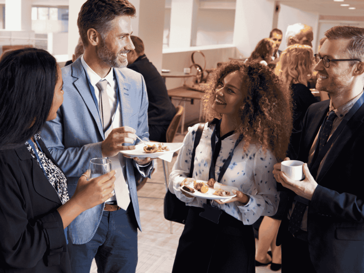 a group of people chat and enjoy the catering